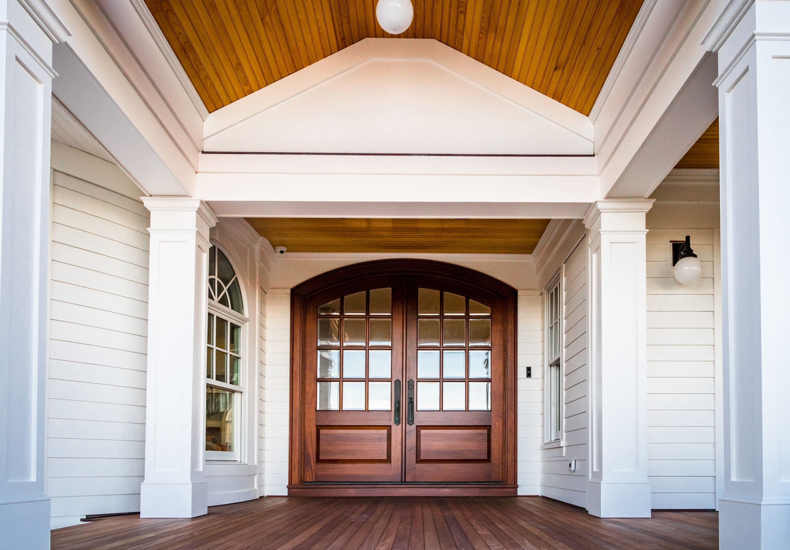 Front entry way of house featuring PVC trim, woodwork, columns,