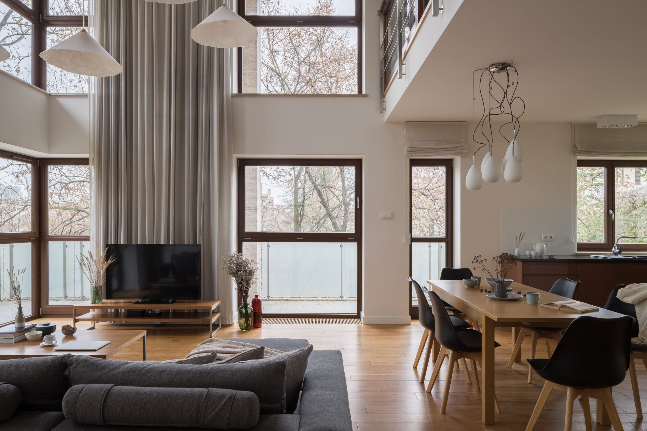 Stylish and luxury two-floor apartment with living room, dining room and kitchen in one room with amazing big windows
